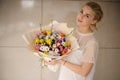 Girl holding a spring bouquet of different color flowers with branches Royalty Free Stock Photo