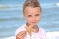 Girl holding a starfish Royalty Free Stock Photo