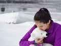 Girl Holding Stuffed Polar Bear by the Icy Water