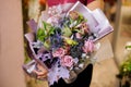 Girl holding a bouquet of roses,dried poppies and purple leaves