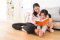 Girl holding teddy bear watching new story book Royalty Free Stock Photo