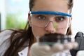 Girl is holding test tube with earth palm her hand