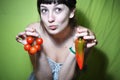 Girl holding tomato and pepper