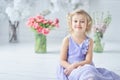 girl holding tulips in hands. Adorable smiling little girl holding flowers for her mom on mother& x27;s day. Royalty Free Stock Photo