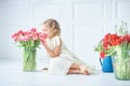 girl holding tulips in hands. Adorable smiling little girl holding flowers for her mom on mother& x27;s day. Royalty Free Stock Photo