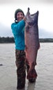 Girl holding up Alaska King Salmon Royalty Free Stock Photo