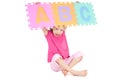 Girl holding up alphabet abc sign Royalty Free Stock Photo