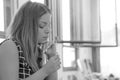 A girl holding a wedding ring doubtfully