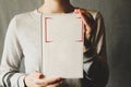 Girl holding a white book in her hands Royalty Free Stock Photo