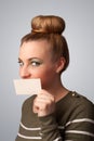 girl holding white card at front of her lips Royalty Free Stock Photo