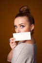 girl holding white card at front of her lips Royalty Free Stock Photo