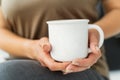 The girl is holding a white cup in her hands. Mug for a woman, a gift Royalty Free Stock Photo