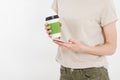 Girl holding white phone.Plastic cup of coffee. Cellular isolated on white clipping path inside. Top view.Mock up.Copy space.Templ