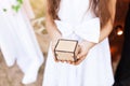 Girl holding a wooden box in her hands, a box for rings Royalty Free Stock Photo