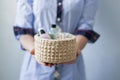A girl holding a wool basket with toiletries
