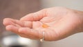 Girl holding Yellow Soft Vitamin Gel Pill