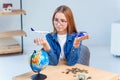 Girl holds airplane and car models in hands and choosing best transportation for trip.Travel around the world for your