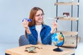 Girl holds airplane and car models in hands and choosing best transportation for trip.Travel around the world for your