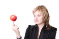 Girl holds an apple on a finger Royalty Free Stock Photo