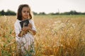 Girl holds bible in her hands. Reading the Holy Bible in a field. Concept for faith, spirituality and religion. Royalty Free Stock Photo