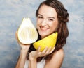 Girl holds in really big citrus fruit - pamelo,