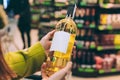 A girl holds a bottle of wine in the store