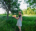 Girl holds a burning book in her hands. A young woman in a forest burns a book Royalty Free Stock Photo