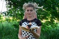 Girl holds a burning book in her hands. A young woman in a forest burns a book Royalty Free Stock Photo