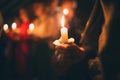 The girl holds a burning candle in her hand Royalty Free Stock Photo