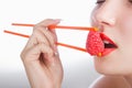 Girl holds chopsticks a raspberry Royalty Free Stock Photo