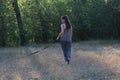 A girl holds a dog on a leash. Walk in the Park