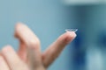Girl holds finger on a contact lens, closeup Royalty Free Stock Photo