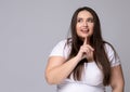 Girl holds finger at mouth urging to keep silence