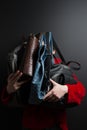 Girl holds in front of leather bags of different colors, girl holds in front of leather bags of different kinds, four new leather