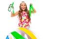 Girl holds glasses and scuba diving flippers near an inflatable ball on a white background