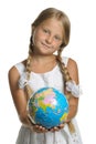 The girl holds the globe collected from puzzle Royalty Free Stock Photo