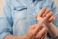 The girl holds and glues the patch on the hand, on the wound, treatment, throwing while smoking Royalty Free Stock Photo