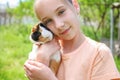 Girl holds guinea pig in her hands. Concept of child taking care of pet Royalty Free Stock Photo