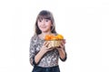 The girl holds in hand a plate with tangerines