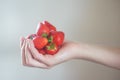 Girl holds a handful of fresh pure strawberries in her palms.