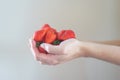 Girl holds a handful of fresh pure strawberries in her palms.