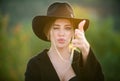 Girl holds hands like a gun. Beautiful girl face closeup, outside portrait of young woman. Summer romantic western woman Royalty Free Stock Photo