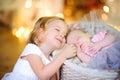 Girl holds her hand and gently snuggles up to her little sister Royalty Free Stock Photo