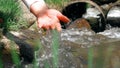 Girl Holds Her Hand On The Water