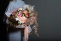 Girl holds in her hands original bouquet in vintage style, greeting background or concept