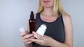 Girl holds in her hands three eco-friendly antiperspirants with natural ingredients.