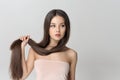 Girl holds her long hair on her arm Royalty Free Stock Photo