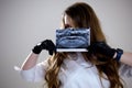 Girl holds her X-ray with a panorama of baby teeth and the second row of replaceable molars. Two rows of teeth, change