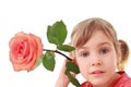 Girl holds large rose near an ear, focus on face