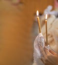 girl holds a lighted candle in her hands, a religious tradition Royalty Free Stock Photo